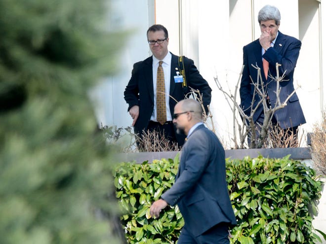 U.S. Secretary of State John Kerry, right, walks outside the hotel during a break of a bilateral meeting with Iranian Foreign Minister Mohammad Javad Zarif for a new round of Nuclear Talks, in Lausanne, Switzerland, Thursday, March 19, 2015. (AP Photo/Keystone,Laurent Gillieron)