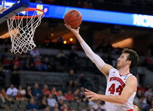 Wisconsin's Frank Kaminsky (44) scores on a rebound during the second half of an NCAA tournament college basketball game against Coastal Carolina in the Round of 64 in Omaha, Neb., Friday, March 20, 2015.