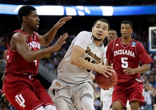 Wichita State guard Fred VanVleet, center, drives to the basket between Indiana's Robert Johnson, left, and Troy Williams (5) during the second half of an NCAA tournament college basketball game in the Round of 64, Friday, March 20, 2015, in Omaha, Neb. VanVleet scored 27 points as Wichita State won 81-76