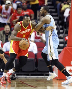 Houston Rockets' Joey Dorsey (8) pushes against Denver Nuggets' Darrell Arthur in the first half of an NBA basketball game Thursday, March 19, 2015, in Houston. (AP Photo/Pat Sullivan)