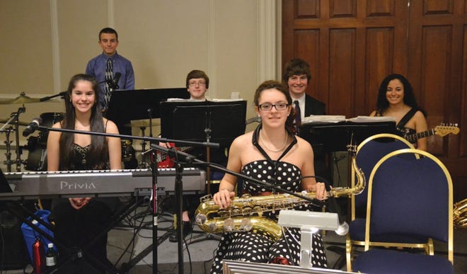 Members of the rhythm section of the LHS Jazz Band smile for the camera. Sitting at bottom left is Jesse Blackman, a freshman who was the piano soloist at the Icicle Ball.