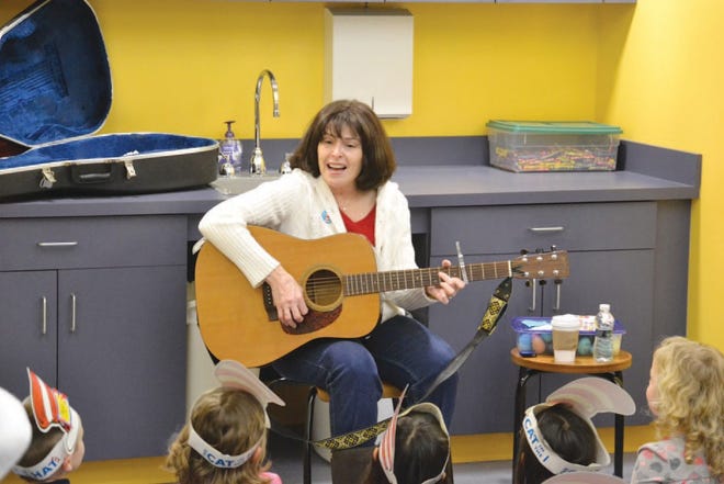 Janice Caskone-Kenyon sings and plays the guitar.