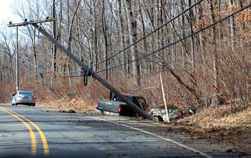 Photo by Tracy Klimek/New Jersey Herald A pickup truck sits off the road in a ditch behind a leaning utility pole on Waterloo Road in Byram Thursday after the vehicle drove off the roadway.