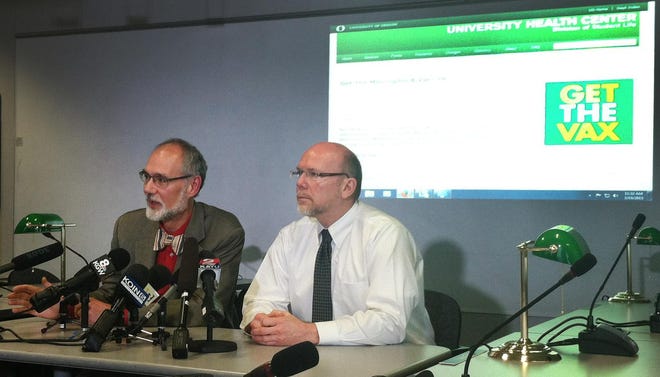 Dr. Paul Cieslak (left) of the Oregon Health Authority's Public Health Division and Dr. Pat Luedtke, Lane County’s public health officer, speak Thursday at a press conference in Portland, where they urged parents of University of Oregon students to press them to get vaccinated for meningococcal disease. (Saul Hubbard/The Register-Guard)