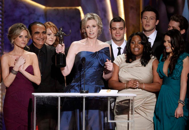 FILE - In this Jan. 23, 2010 file photo, Jane Lynch, center, and the cast of "Glee" accept the award for best ensemble in a comedy series at the 16th Annual Screen Actors Guild Awards in Los Angeles. "Glee" will conclude its six-season run with a two-hour finale on Friday, March 20, 2015. (AP Photo/Mark J. Terrill)