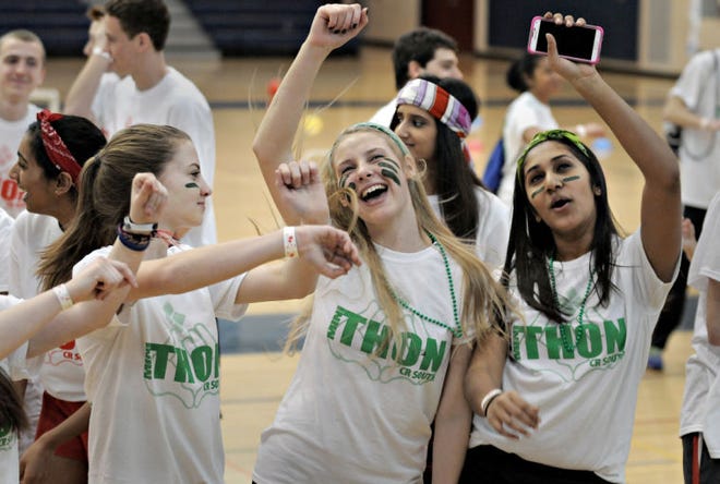 From left, Megan Harding, Sophia Datsko and Sharon Joseph dance to the music during the 12-hour marathon of dance and other activities to benefit the Four Diamonds Fund that fights childhood cancer Saturday, March 21, 2015 at Council Rock High School South in Northampton.