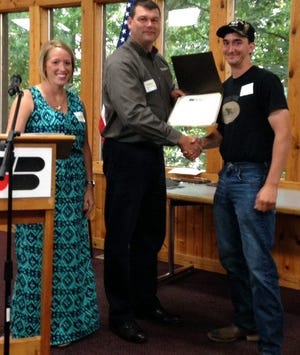 Zach Sanborn receives the Young Farmer Achievement Award at the Hillsdale County Farm Bureau Award Ceremony. COURTESY PHOTO