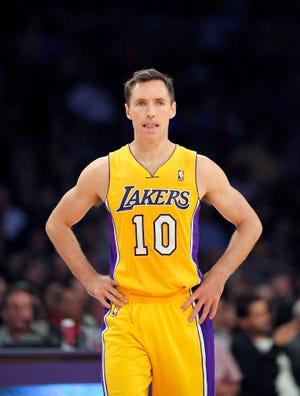 FILE - In this April 8, 2014, file photo, Los Angeles Lakers guard Steve Nash looks on during the first half of an NBA basketball game against the Houston Rockets in Los Angeles. Nash announced his retirement Saturday, March 21, 2015 after a 19-year NBA career that included two MVP awards. The 41-year-old Canadian made the announcement Saturday in a letter on The Players' Tribune, a website where he is a senior producer. Nash played in just 65 games over the last three seasons with the Lakers due to injuries. His announcement was a long-expected formality. (AP Photo/Mark J. Terrill, File)