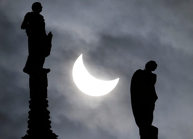A partially eclipsed sun is seen Friday between two statues at the Duomo 
gothic cathedral in Milan, Italy. A partial solar eclipse could be seen 
across much of Europe and parts of Asia and Africa.
AP PHOTO / ANTONIO CALANNI