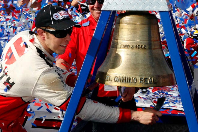 Brad Keselowski rings the El Camino Real bell to celebrate winning the NASCAR Sprint Cup race in Fontana, Calif. on Sunday.