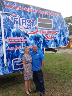 Anne-Marie Poulin, left, and her husband Ken stand in front of a trailer at their Edgewater business. The company is in the process of opening a second office in Orlando.