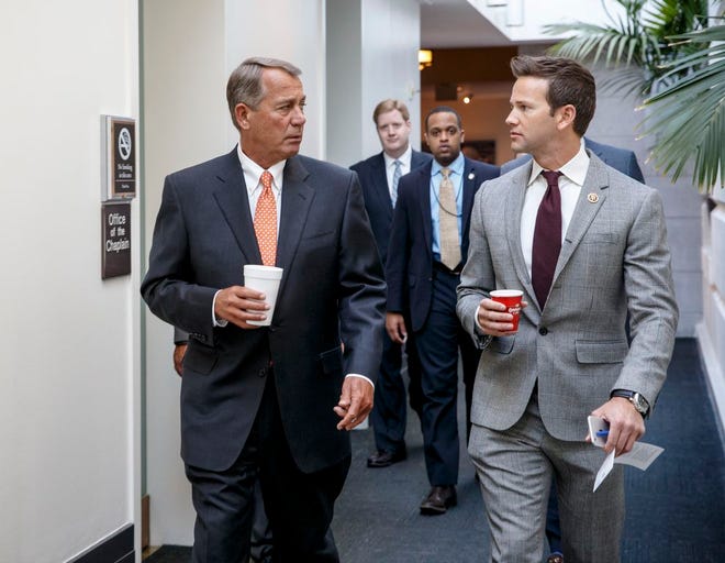In this Jan. 9, 2015, file photo, House Speaker John Boehner of Ohio, left, walks with Rep. Aaron Schock, R-Ill., on Capitol Hill in Washington. (AP Photo/J. Scott Applewhite, File)