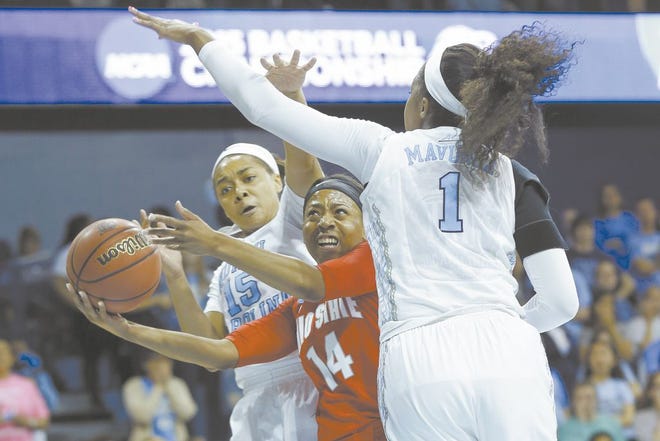 Ohio State’s Ameryst Alston goes to the basketball between North Carolina’s Allisha Gray and Stephanie Mavunga (1) during the first half Monday in Chapel Hill, N.C. The McKinley High School product scored 30 points.