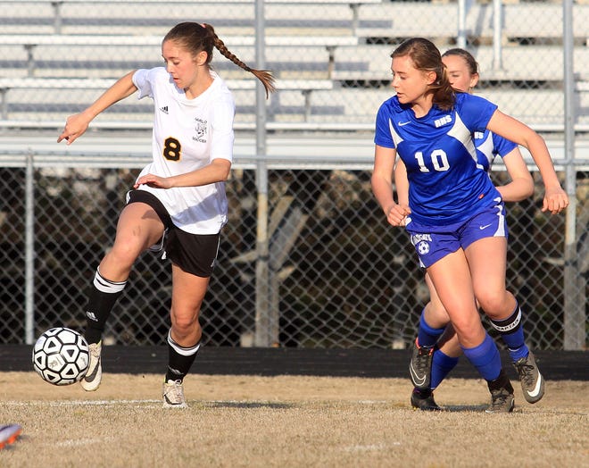 Havelock's Kaylee Larson, left, plays the ball in front of Richlands' Nicki Thompson during a Coastal 3A Conference match Tuesday at Havelock High. Larson had two first-half goals for the Rams, who won the match 5-1.