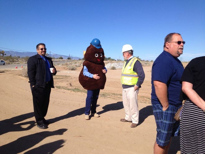 'Mr. Dingle,' the mascot for the Victor Valley Wastewater Reclamation Authority, shares his insights with a VVWRA employee during the groundbreaking ceremony of a water reclamation plant in Hesperia on Tuesday.