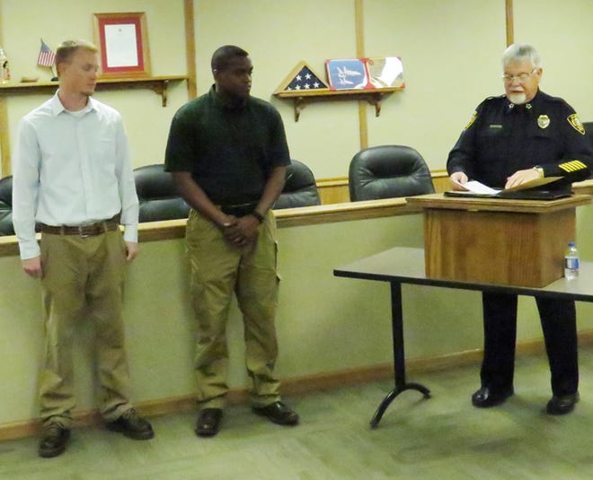 New Aledo police officers Adam Baker, left, and Anthony Johnson, center, are introduced by Aledo Police Chief J. Michael Sponsler.