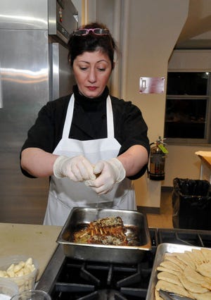 Chef Sofia Karakasidou prepares Herb Crusted Lamb Chops during a class at the Burlington County Community Agricultural Center in Moorestown.
