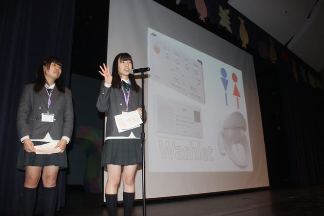 Yumi Yonemori, a student from Omiya Nishi High School in Saitama, Japan, tells Adrian High School students Tuesday about Japan’s modern conveniences as part of a cultural exchange presentation. Yonemori and 24 of her schoolmates are visiting Adrian this week through the Kakehashi Project, a U.S.-Japan youth exchange program.