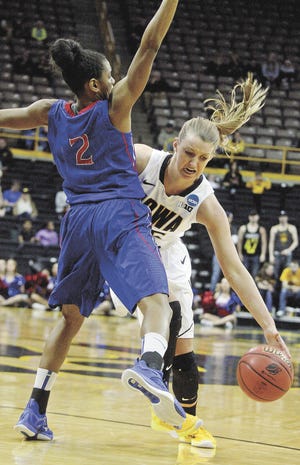 John Gaines/The Hawk Eye Iowa's Kali Peschel drives into American's Shaquilla Curtis (2) in the first round of the NCAA Division I Women's Basketball Tournament Friday at Carver-Hawkeye Arena in Iowa City.