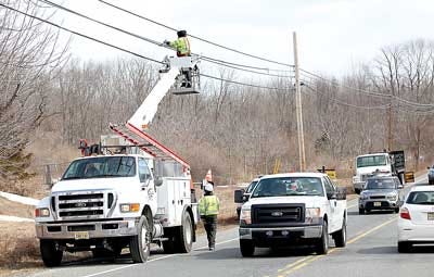 Photo by Tracy Klimek/New Jersey Herald Motorists drive past workers with High Point Utilities as they work on the lines on Route 94 in Sparta last week.