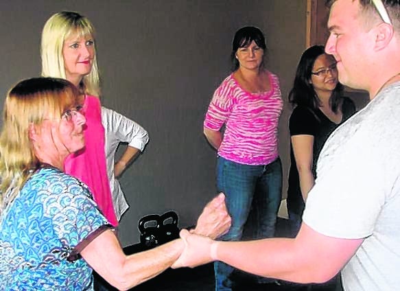 Diana McLeod, left, escapes from a wrist grab from J.R. Crosby, an 
instructor for Sarasota's tactical training firm Advanced Defensive 
Concepts, while Kim Wheeler and Stacey Tucker watch the demonstration, 
during a women's self-defense class on Thursday.
STAFF PHOTO / LEE WILLIAMS