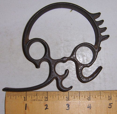 This 100 year multifunctional cast iron tool was used in a 19th century kitchen, but it was not used directly with food. Can you guess where and how it was used