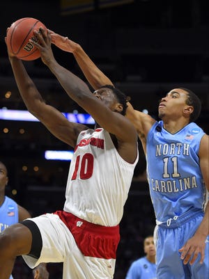 Wisconsin forward Nigel Hayes (10) shoots against North Carolina forward Brice Johnson (11) during the first half of a college basketball regional semifinal in the NCAA Tournament, Thursday, March 26, 2015, in Los Angeles.