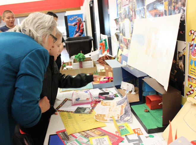 Fifth-grade students show their "Esperanza Rising" projects and dioramas to METS director Maryellen Whittington-Couse. Pat DeMono/For the Gazette