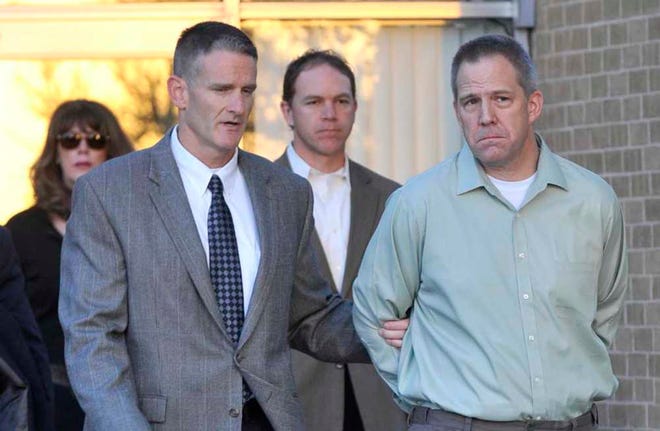 JetBlue pilot Clayton Frederick Osbon, right, is escorted to a waiting vehicle by FBI agents as he is released from The Pavilion at Northwest Texas Hospital on April 2, 2012. Osbon was taken directly to the Federal Court Building for arraignment.
