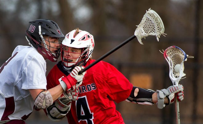 Holy Ghost Prep beats Abington High School 12-8 in a lacrosse game in Abington Friday evening, March 27, 2015. Here Holy Ghost Prep's Travis Incollongo runs behind the net as Abington's Ryan Fetzer defends.