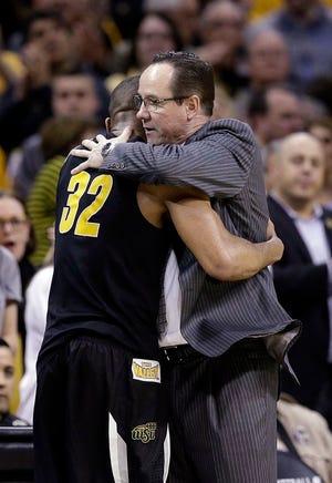 Wichita State coach Gregg Marshall hugs Tekele Cotton (32) after the team's 81-70 loss to Notre Dame in a college basketball game in the NCAA men's tournament regional semifinals, Thursday, March 26, 2015, in Cleveland.