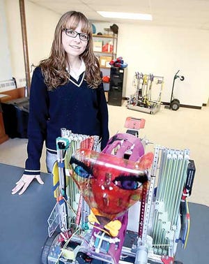 Photo by Marie Dirle/New Jersey Herald Gaige Moore, a Pope John sophomore and finalist for the FIRST Tech Challenge Robotics Dean’s List Award, shows off her team’s robot in the robotics lab at Pope John XXIII Regional High School in Sparta.
