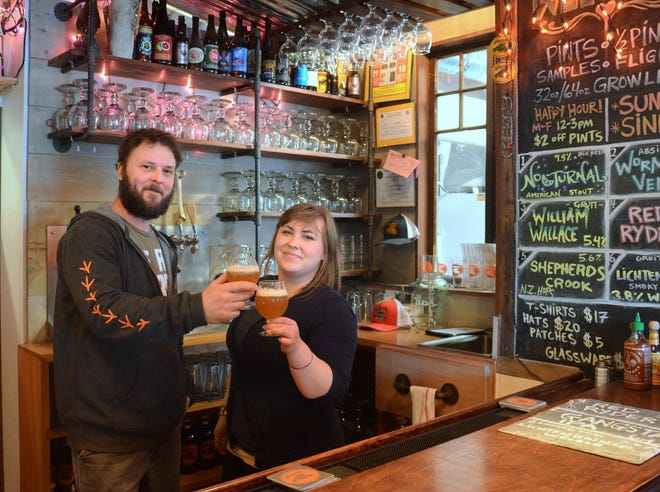 Earth Eagle Brewings on High Street in Portsmouth, was named No. 14 in a list of the top 21 New England breweries in the April issue of Boston magazine. Toasting the good news is owner and brewer Alex McDonald and bartender Sarah Bryan. Suzanne Laurent photo