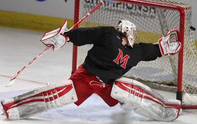 Miami University goalie Jay Williams stretches for a puck that sails wide of the net during Friday's practice at the Dunkin' Donuts Center.