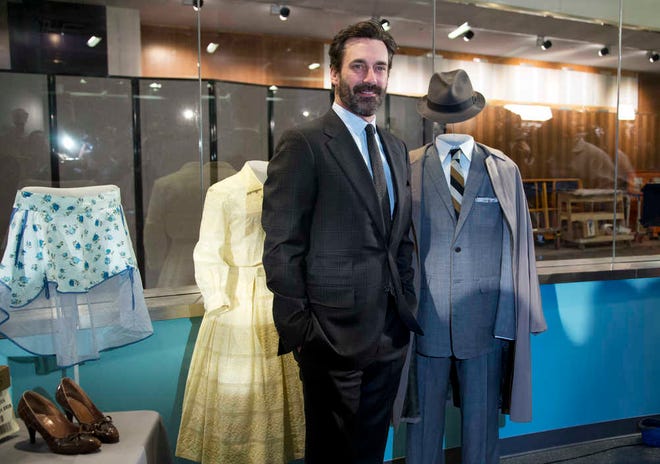 "Mad Men," cast member Jon Hamm who played Donald Draper, poses beside Don's charcoal grey suit and some objects AMC and Lionsgate TV series, "Mad Men" that were donated to the National Museum of American History, Friday, March 27, 2015, in Washington.  (AP Photo/Manuel Balce Ceneta)