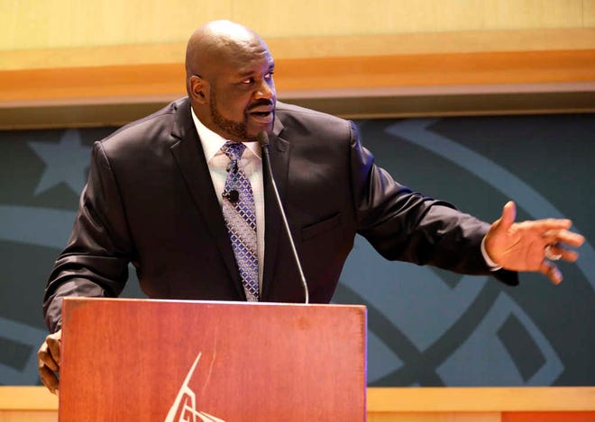 Former NBA player Shaquille O'Neal makes comments during a ceremony inducting him in the Magic Hall of Fame, Friday, March 27, 2015, in Orlando, Fla. Selected by Orlando with the first overall pick of the 1992 NBA Draft, O'Neal spent four seasons with the Magic from 1992-96. (AP Photo/John Raoux)