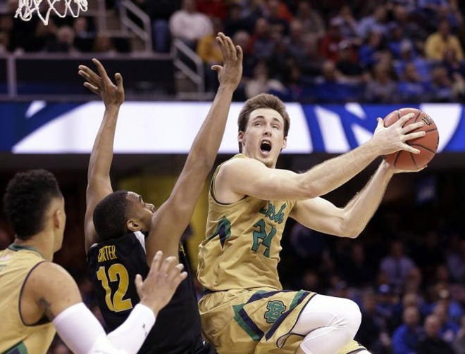 Notre Dame's Pat Connaughton goes up against Wichita State's Darius Carter (12) during the second half of a college basketball game in the NCAA men's tournament regional semifinals, Thursday, March 26, 2015, in Cleveland.