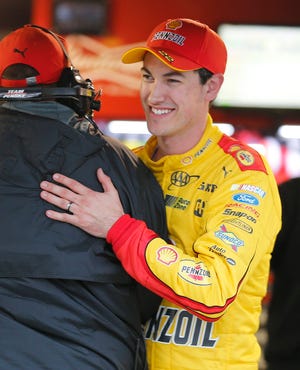Joey Logano, right, celebrates winning the pole for Sunday's Sprint Cup race at Martinsville Speedway in Martinsville, Va. The Associated Press