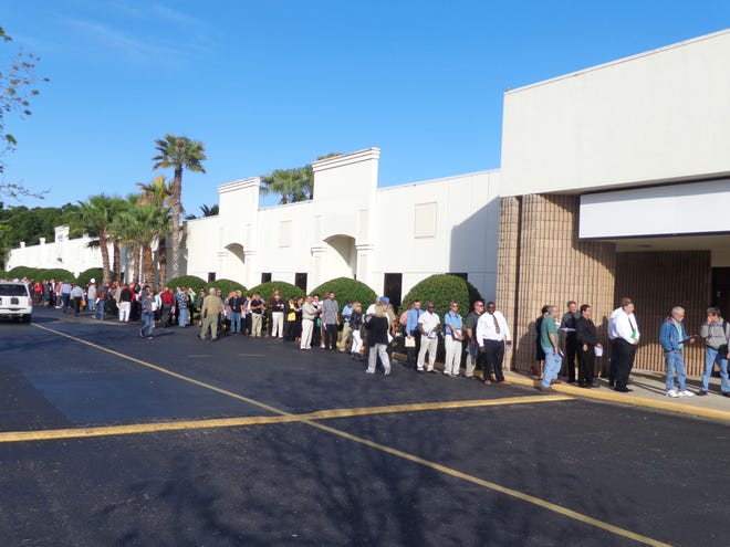 Job seekers line up at Speedway Business & Retail Center behind the Volusia Mall for the hiring event.
