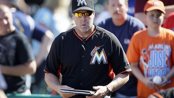 Miami Marlins manager Mike Redmond packs up after a spring training exhibition baseball game against the Detroit Tigers in Lakeland, Fla., Wednesday, March 25, 2015. (AP Photo/Carlos Osorio)