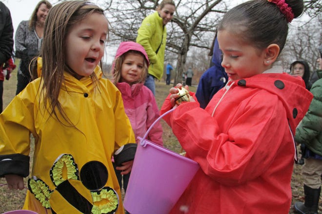 Angela Pirri, 6, and Mekayla Neves, 5, both of Bristol, take part in the Camouflaged Egg Hunt at the Audubon Environmental Education Center in Bristol. Mekayla found a golden egg that had a toy otter inside. 

The Providence Journal/Sandor Bodo