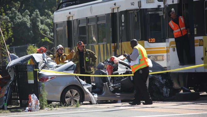 Irfan Khan/Los Angeles TimesEmergency personnel work at the site of a collision between and Expo Line commuter train and a vehicle near downtown Los Angeles on Saturday. Firefighters say nearly two dozen people suffered injuries, mostly minor.