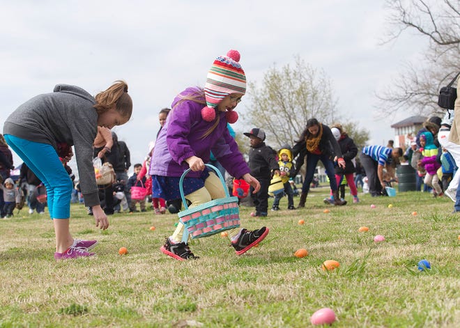 Adie Toler (center) scurries for eggs during the Easter Eggstravaganza held at Union Point Park Saturday morning.
