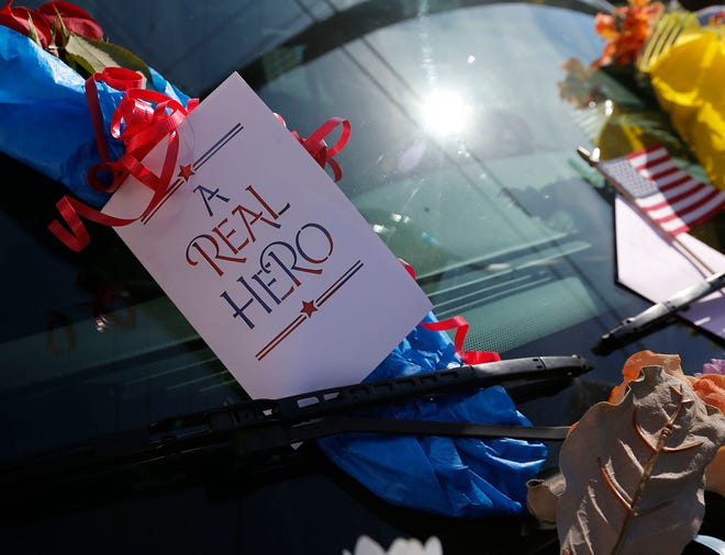 This card and others, along with flowers, teddy bears and other memorials covered Officer Thalmann’s patrol car which was displayed in front of the New Bern police station for several days after his death.