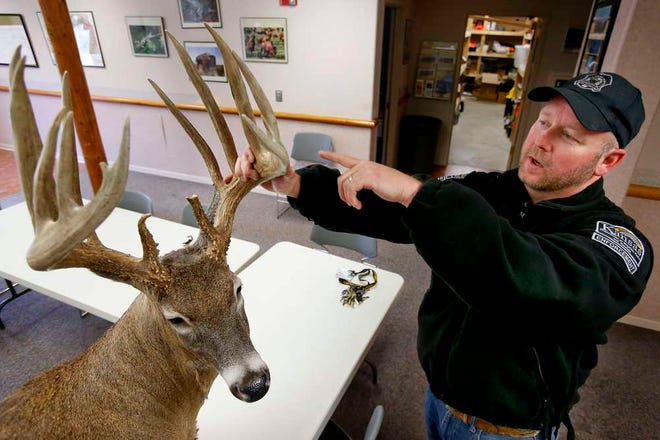 Lt. Jason Sawyers with the Kansas Department of Wildlife, Parks and Tourism points out the nearly flawless antlers of a deer that was poached in 2011 in Osage County.