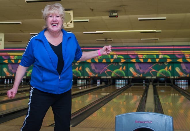 Diane Bowers-Lynch, of Bellmawr, celebrates after knocking down all but one pin during a fundraiser for to benefit homebound patients at Samaritan's sister hospice, Kawempe Home Care in Kampala, Uganda hosted by Samaritan Healthcare and Health at Laurel Lanes Bowling Alley in Maple Shade, NJ, Friday, March 27, 2015. Photo by Bryan Woolston.