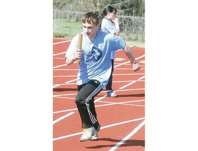 Bartlesville’s Gage George focuses as he hustles down the Dewey High School track during Saturday’s Grand Area Special Olympics competition. George is a 10th-grader. Mike Tupa/Examiner-Enterprise