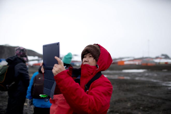 A tourist uses a tablet take a picture Feb. 2 after disembarking from the Ocean Nova cruise ship on King George Island, Antarctica.