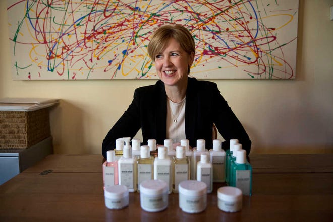 In this photo taken Friday, Jan. 30, 2015, aromatherapist Emma Arkell poses for a portrait with one of the natural remedies for the skin and body she makes near Winchester, England. Evidence is growing that gender equity is not just politically correct window-dressing, but good business. Yet while companies are trying to increase the number of women in executive positions, many are struggling because of a failure to adapt workplace conditions in a way that ensures qualified women do not drop off the corporate ladder. (AP Photo/Matt Dunham)