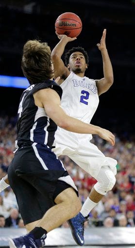 Duke's Quinn Cook (2) shoots over Gonzaga's Kevin Pangos during the second half of a college basketball regional final game in the NCAA Tournament Sunday, March 29, 2015, in Houston. (AP Photo/Charlie Riedel)